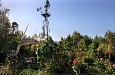a windmill in the middle of a garden at Troed yr Aran in Aber Cowarch