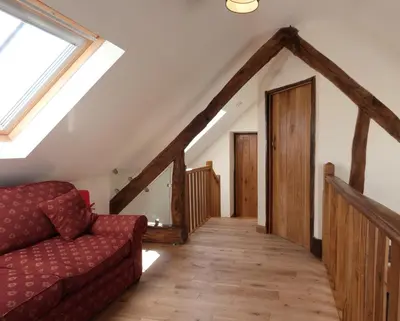 a living room with a couch and a window at Ysgubor y Waun in Tywyn