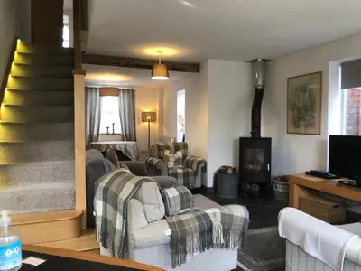 a living room with two couches and a fireplace at Top House in Welshpool