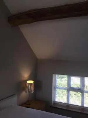 a bedroom with a bed and a window at Top House in Welshpool