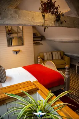 a bedroom with a bed and a couch in a room at The Bear Inn in Llandovery