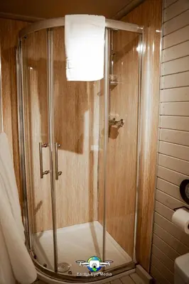 a shower with a glass door in a bathroom at The Bear Inn in Llandovery