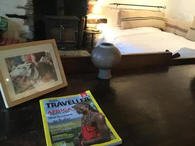 a bedroom with a bed and a magazine on the floor at Half Moon House in Hay-on-Wye