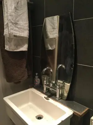 a bathroom with a sink and a mirror and towels at Half Moon House in Hay-on-Wye