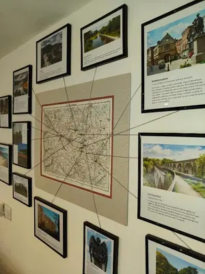 a wall with framed pictures on a wall at The Garden Lodge in Llynclys