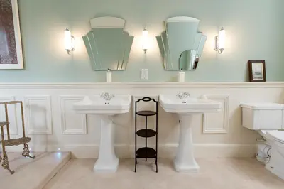 a bathroom with two sinks and two mirrors at Burton Court in Dilwyn