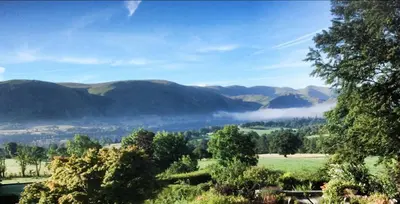 a view of a valley with mountains in the distance at The Old Three Pigeons in Nesscliffe