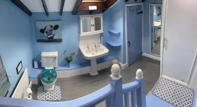 a model of a bathroom with a cow on the wall at Ty Mawr at Bethania B&B Rooms and Crumble Cottage in Llanon