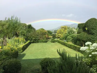 a rainbow over a garden with a lawn at The Smithy in Hay-on-Wye