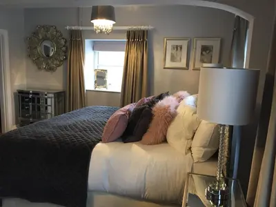 a bedroom with a bed and a table with a lamp at The Town House BnB in Brecon