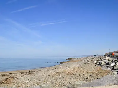 a beach with rocks and the ocean on a clear day at Roath in Cilcennin