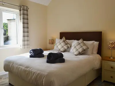 a bedroom with a bed with two towels on it at Roath in Cilcennin