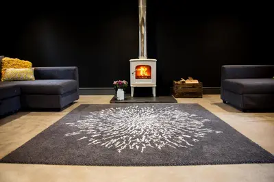 a living room with a fireplace and a rug at Drovers Rest Farm Stay in Hay-on-Wye