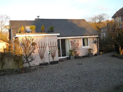 a small house with plants on the side of it at Ty'r Afon - River Cottage in Bala