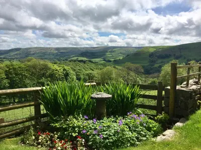 a garden with flowers in front of a fence at Foel Fach in Talerddig