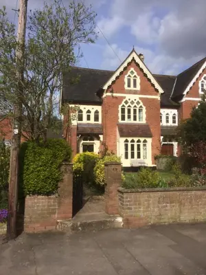 a red brick house with a black roof at Temeside Garden House in Ludlow