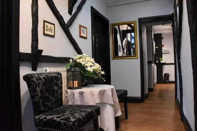 a dining room with a table with a vase of flowers at The Llanelwedd Arms Hotel in Builth Wells