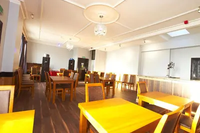 a dining room with wooden tables and chairs at The Black Swan Inn in Leominster