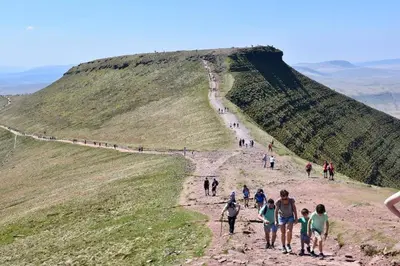 a group of people walking up a hill at Old Castle Farm Guest House in Brecon