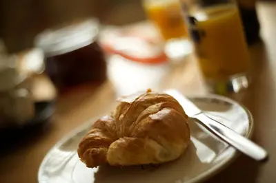 a plate with a croissant on a table at Penrhosmawr in Machynlleth