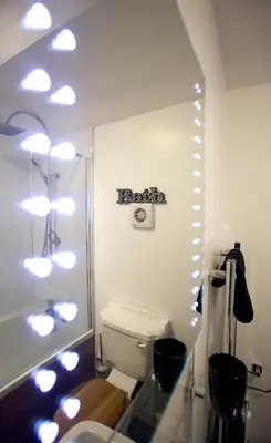 a bathroom with a toilet and a shower with lights at Penrhosmawr in Machynlleth