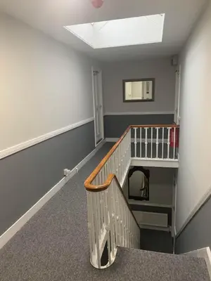 an empty room with a staircase and a stair case at Abbots Mead Hotel in Shrewsbury