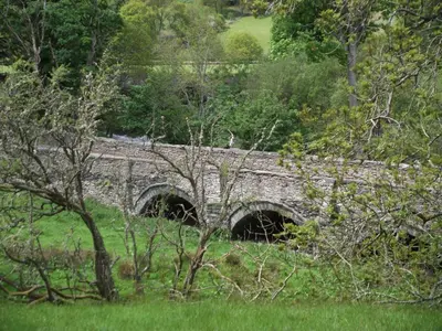 a stone bridge with two tunnels in a field at Bryn Cottage in Llandderfel