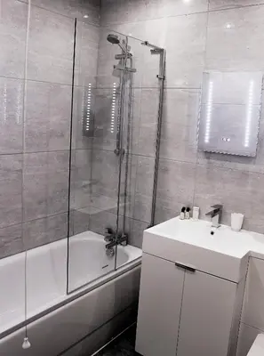 a bathroom with a shower and a sink and a tub at Dee Valley Cottages in Llangollen