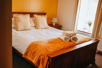 a bedroom with a bed with towels on it at Sunnyside farmstay & hottub near Brecon Beacons sleeps 8 in Lower Chapel