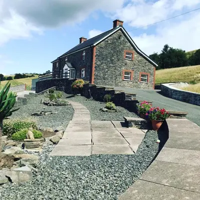 a stone building with a pathway in front of it at Sunnyside farmstay & hottub near Brecon Beacons sleeps 8 in Lower Chapel