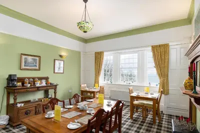 a dining room with a table and chairs at Crown Lodge in Harlech