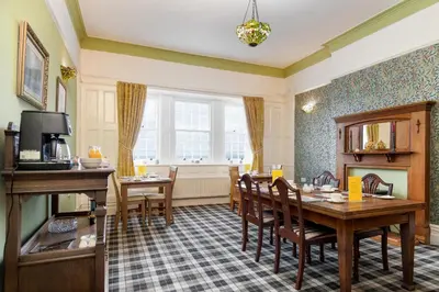 a dining room with a table and chairs at Crown Lodge in Harlech