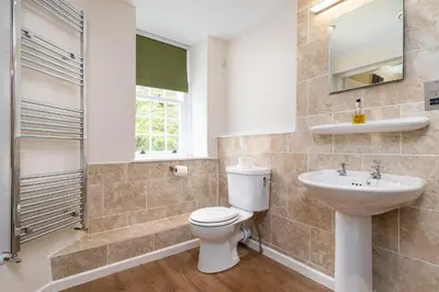 a bathroom with a toilet and a sink at Crown Lodge in Harlech