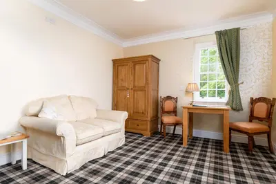 a living room with a couch and a chair at Crown Lodge in Harlech