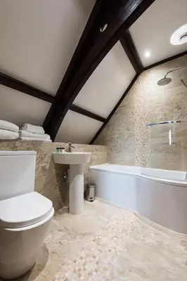 a bathroom with a toilet and a tub and a sink at St Nicholas Boutique Hotel in Shrewsbury