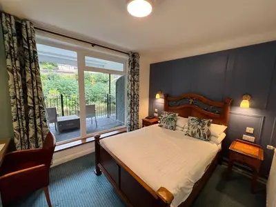 a bedroom with a bed and a large window at The Chainbridge Hotel in Llangollen