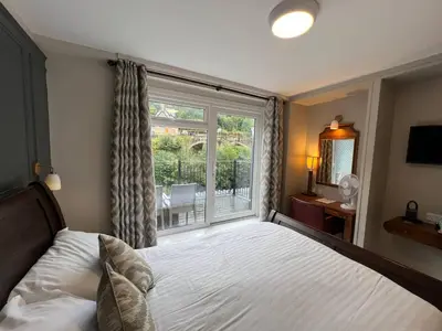 a bedroom with a bed and a large window at The Chainbridge Hotel in Llangollen