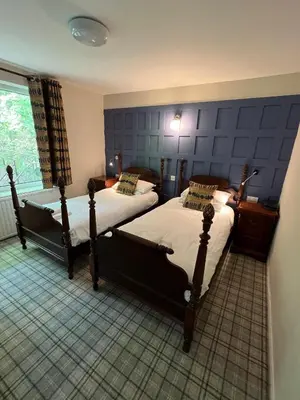 a bedroom with two beds and a window at The Chainbridge Hotel in Llangollen