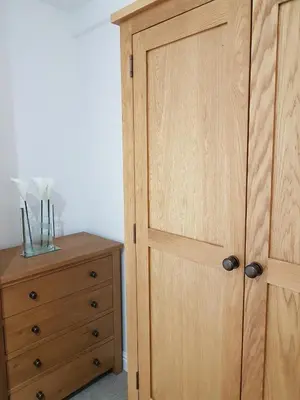 a bedroom with a wooden door and a dresser at Bridge Street in Aberystwyth