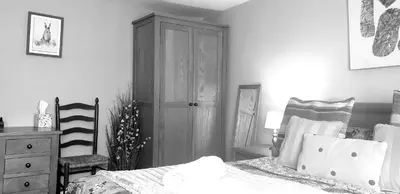 a bedroom with a bed and a wooden cabinet at Bridge Street in Aberystwyth