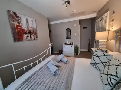 a bedroom with a bed with two towels on it at Bridge Street in Aberystwyth