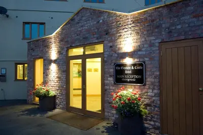 a brick building with a door and a sign on it at The Elephant & Castle Hotel in Newtown