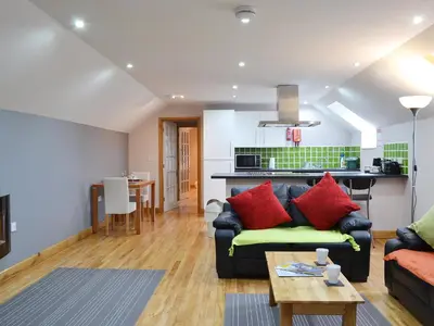 a living room with a couch and a table at The Loft - Uk6210 in Llanerch-Aeron