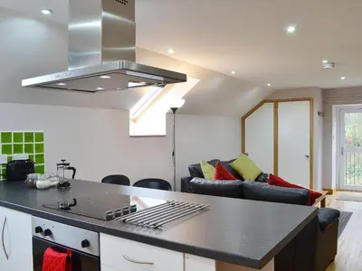 a kitchen and living room with a stove top oven at The Loft - Uk6210 in Llanerch-Aeron