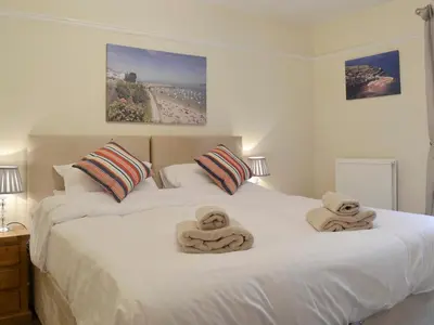 a bedroom with two beds with towels on them at Montrose in New Quay