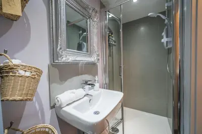 a bathroom with a sink and a mirror and a shower at Beautifully decorated, elegant apartment near town - Pass the Keys in Shrewsbury