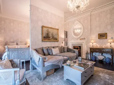 a living room with a couch and a fireplace at Beautifully decorated, elegant apartment near town - Pass the Keys in Shrewsbury