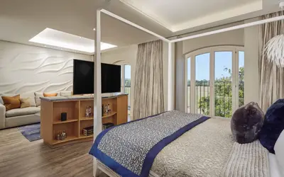 a bedroom with a bed and a tv and a couch at Lion Quays Resort in Oswestry