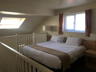 a bed in a room with a window at Moreton Park Hotel in Chirk