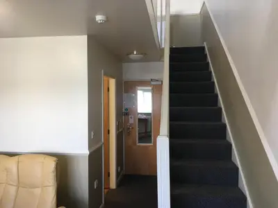 a hallway with stairs leading up to a door at Moreton Park Hotel in Chirk